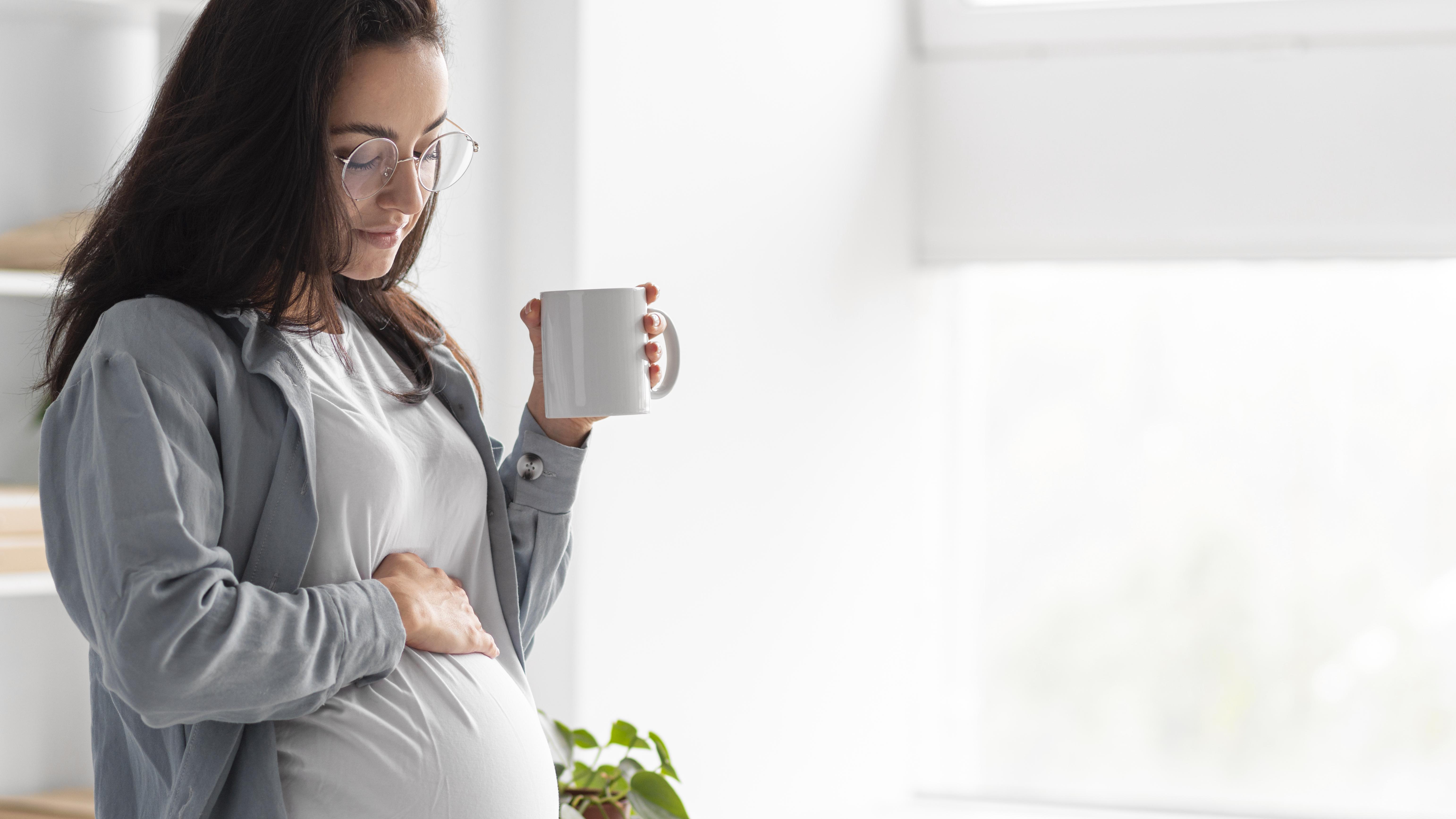 Illustration showing a pregnant person balancing a coffee cup, sleep and calm